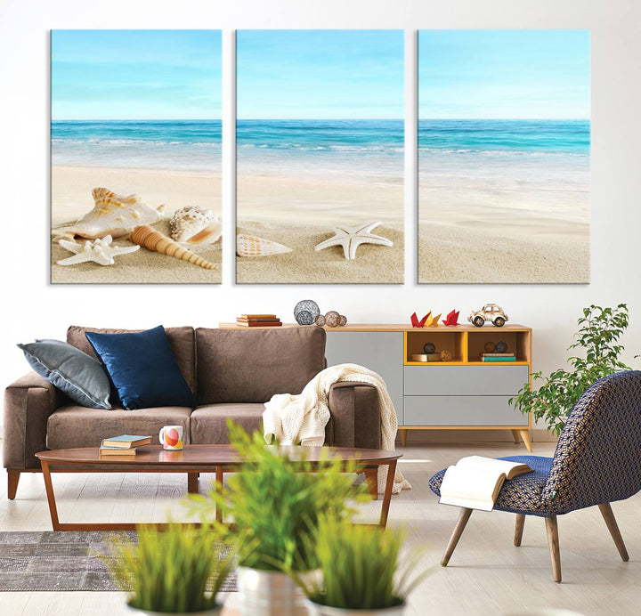 The "Turquoise Ocean View Seashell Starfish on the Beach Canvas Print Artwork" is a triptych piece that showcases a tranquil beach scene, complete with seashells and starfish adorning the sand. It is elegantly gallery-wrapped on museum-quality canvas.