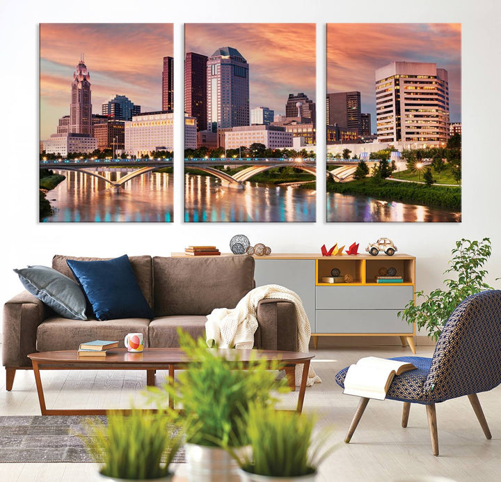 The "Columbus City Lights Sunset Orange Cloudy Skyline Cityscape View" wall art is featured on the wall. This triptych is printed on museum-quality canvas and includes a UV-protective coating, ensuring lasting vibrancy.