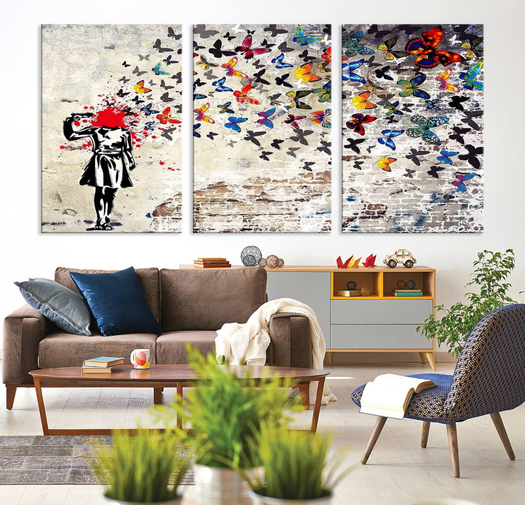 The Banksy Art Butterfly Girl Explosion Canvas showcases a dynamic figure with butterflies bursting from their head, set against a textured wall background. This vibrant urban graffiti piece is perfect for modern interiors and comes ready to hang.