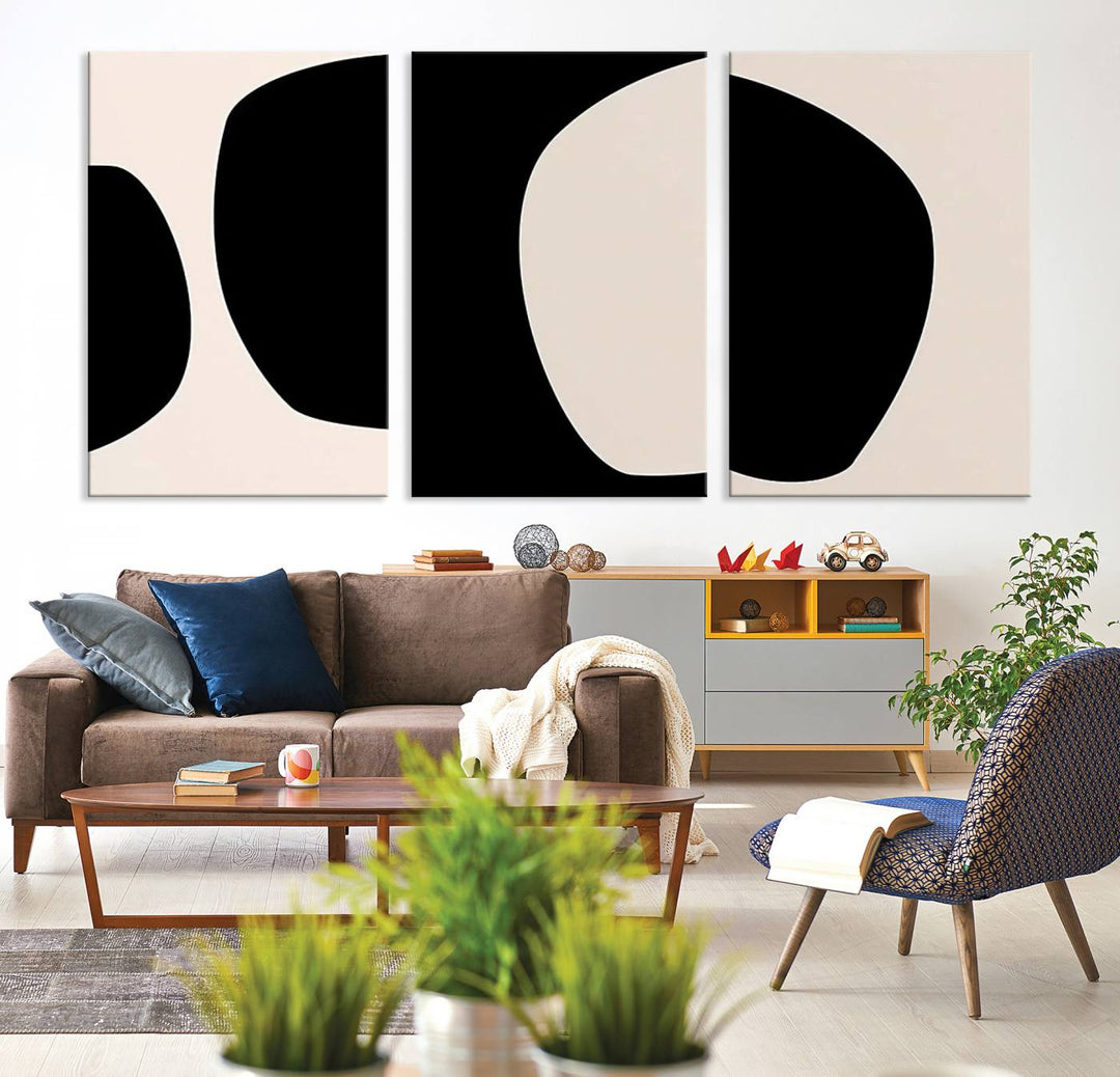 The highlight of the room is the "3 Piece Canvas Wall Art Abstract," featuring an abstract black and white triptych on canvas. It is enhanced with a UV-protective coating to provide museum-quality durability and sophistication.