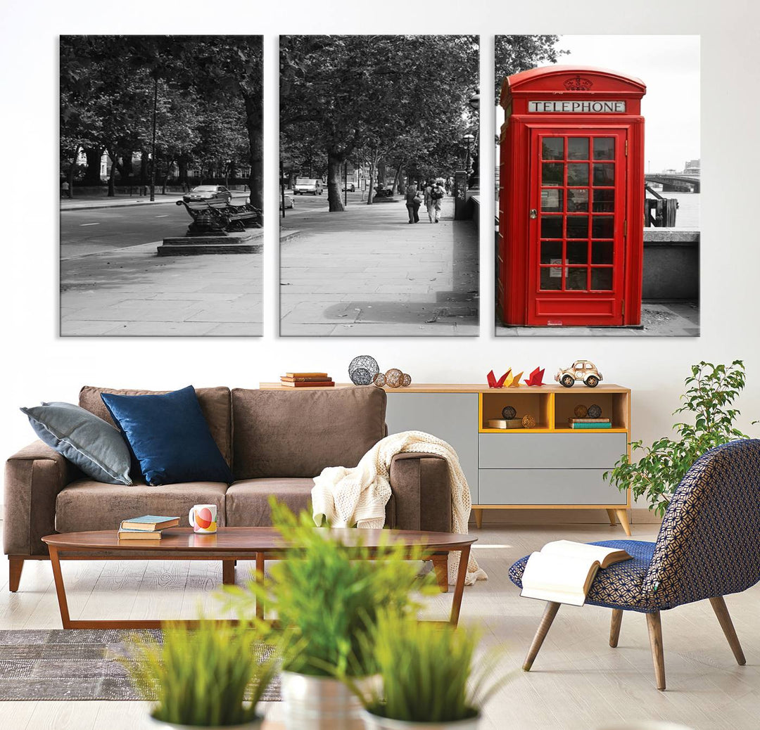 The London Phone Club Wall Art is a stunning piece that showcases a red telephone box set in a black and white street scene on museum-quality canvas. It is gallery wrapped with a UV-protective coating to preserve its vibrant charm.