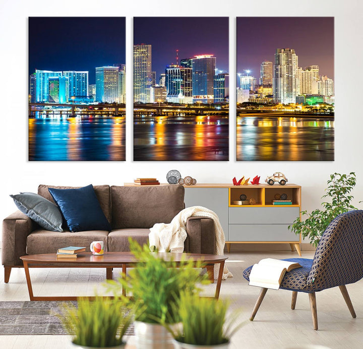 The Wall Art MIAMI Canvas Print features a stunning triptych of a city skyline at night, with vibrant lights reflecting on the water. This gallery-wrapped piece on museum-quality canvas delivers an exquisite finish.