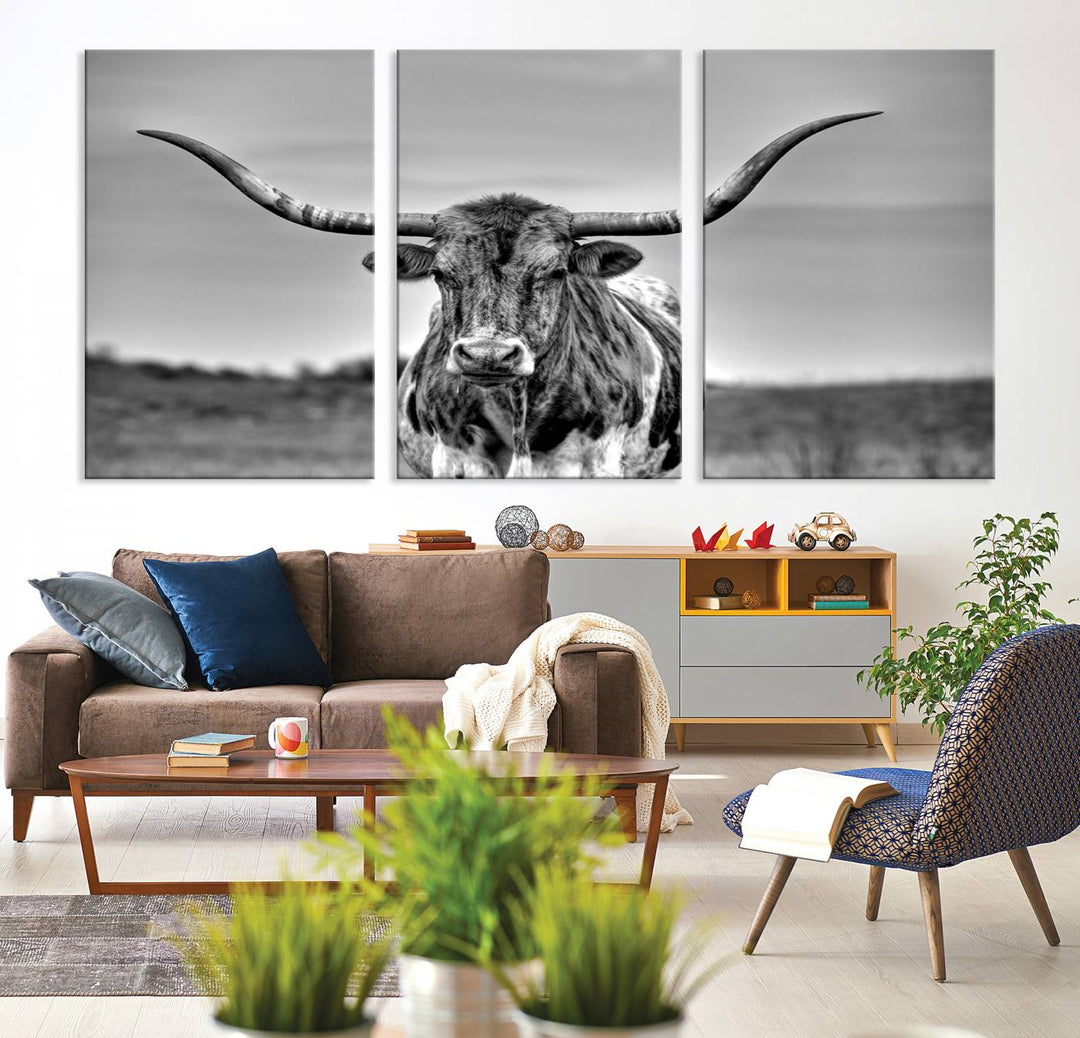 The Texas Longhorn Cow Wall Art, featuring a black and white image of a longhorn bull on canvas, brings charm to the room with its sophisticated appeal.