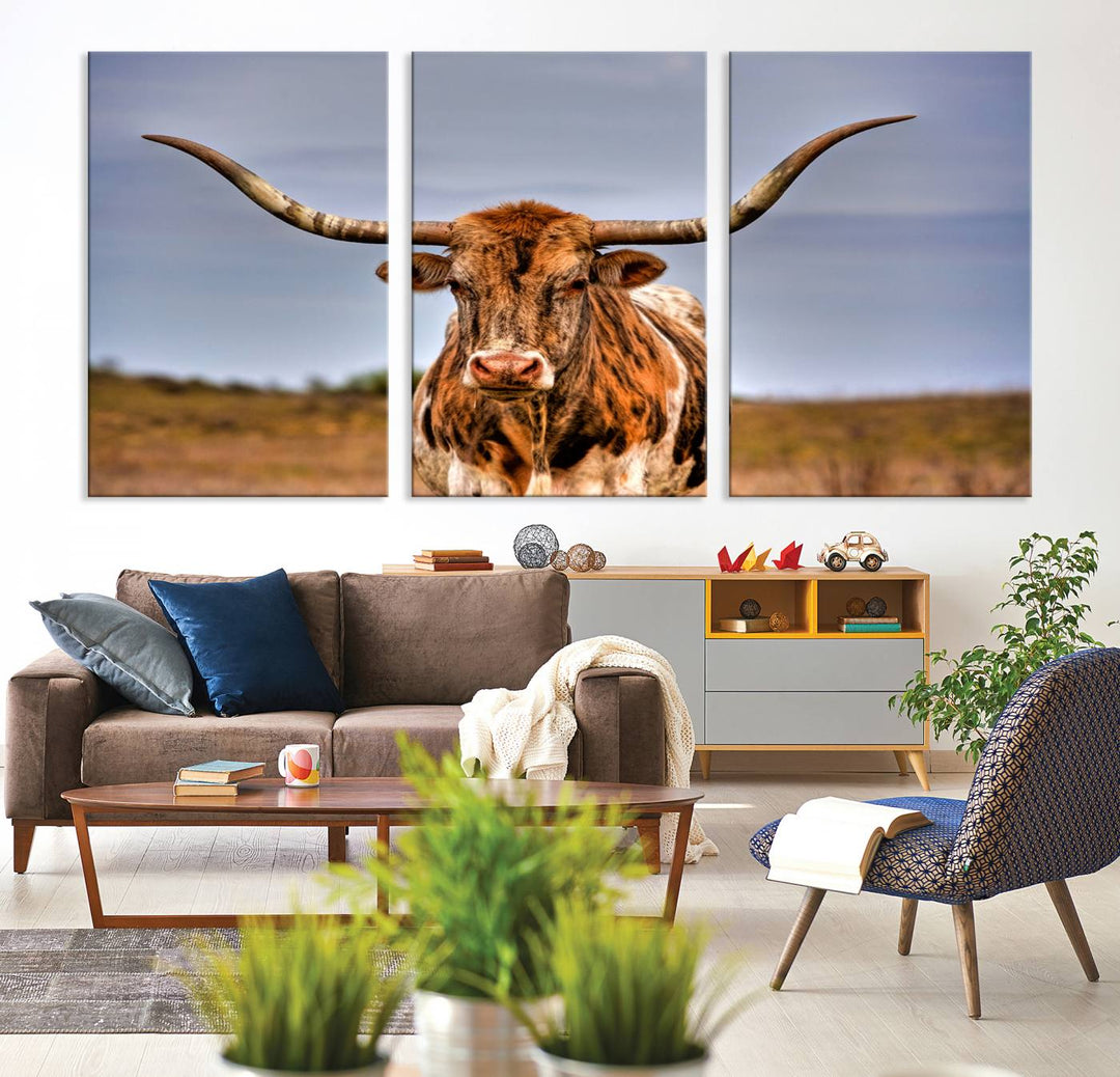 The Texas Longhorn Wall Art Print, a triptych canvas artwork depicting a longhorn bull in a field, features a gallery-quality finish.