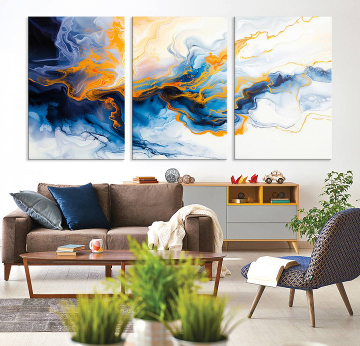 A stunning Fluid Alcohol Ink Wall Art with Gold Wall Art Canvas Print, featuring vibrant blue, orange, and white swirls, adorns the wall. This gallery-quality finish adds an exquisite touch to any living space.