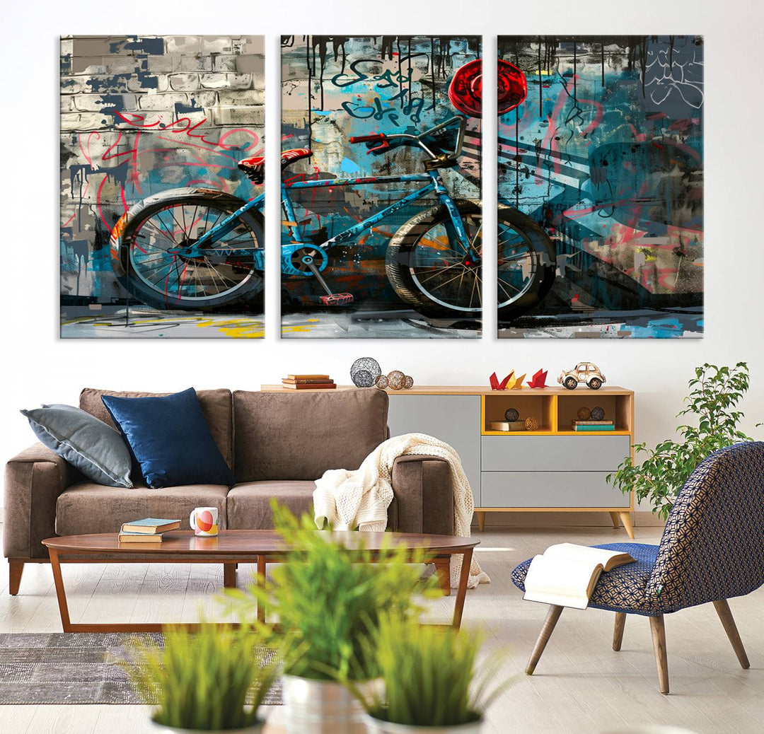 A modern living room features a triptych wall art of an abstract bicycle, designed in a graffiti style on a brick wall. This piece is expertly crafted on the Abstract Bicycle Wall Art Canvas Print, offering a premium canvas that ensures a gallery-quality finish.