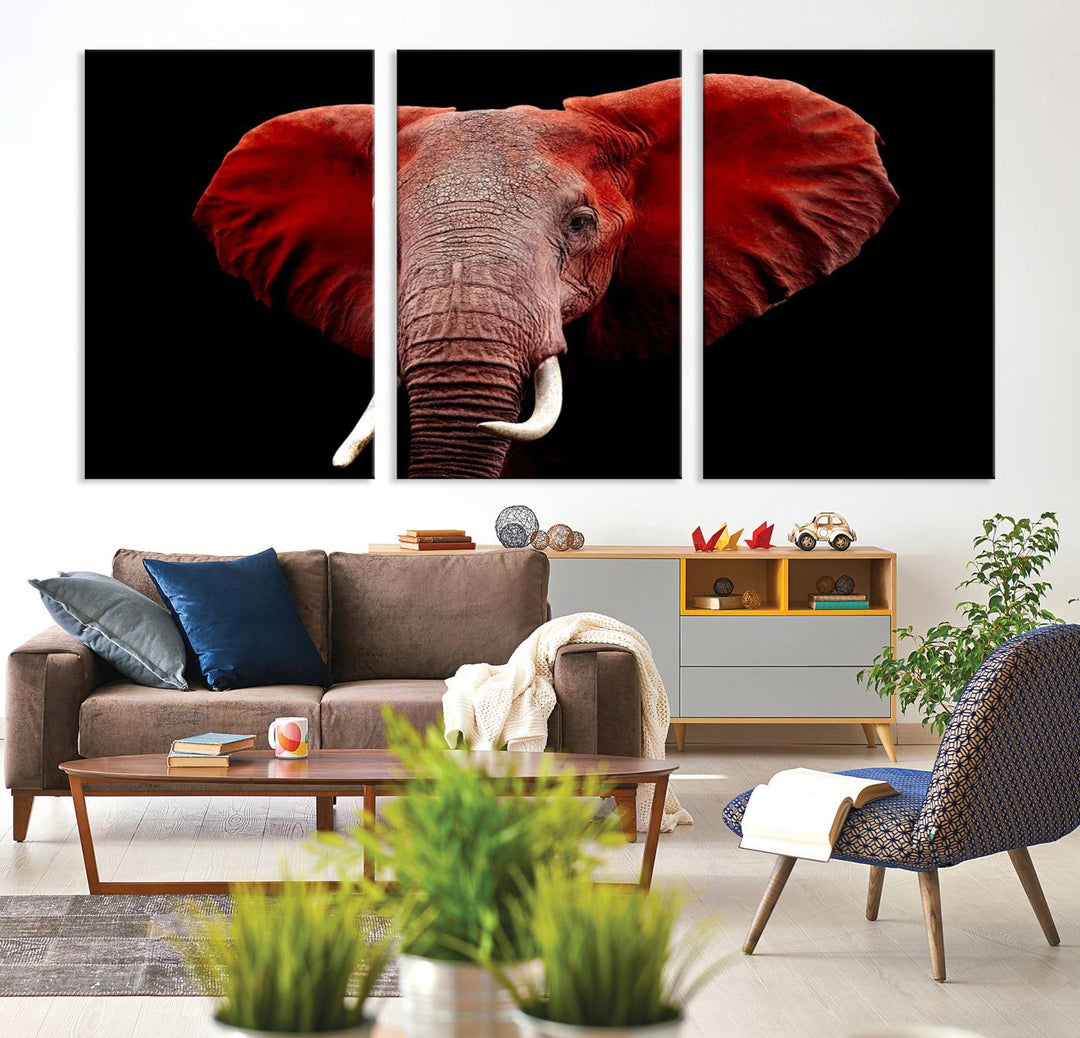 A Wall Art Canvas Print in the modern living room features a three-panel premium design of a red elephant face.