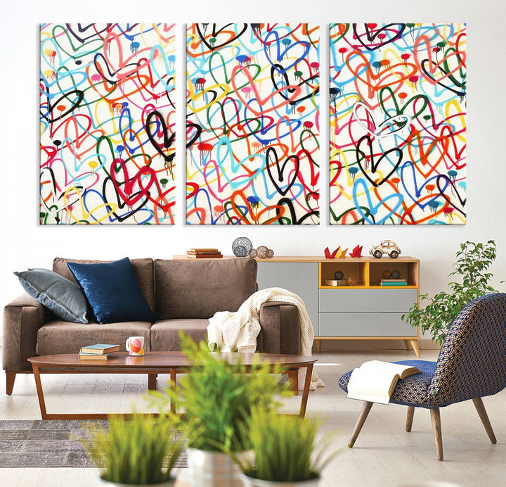 The Colorful Graffiti Love Canvas Print, a street art masterpiece with vibrant abstract swirls and a gallery-quality finish, hangs prominently on the wall.