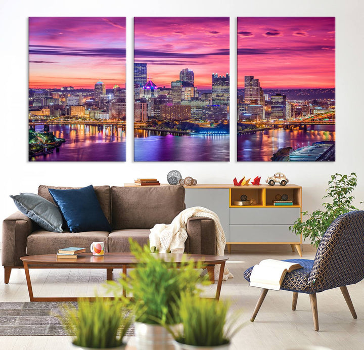 The Pittsburg Wall Art Canvas Print, showcasing a vibrant sunset glow over the city skyline and crafted by a professional artisan, adorns the space.