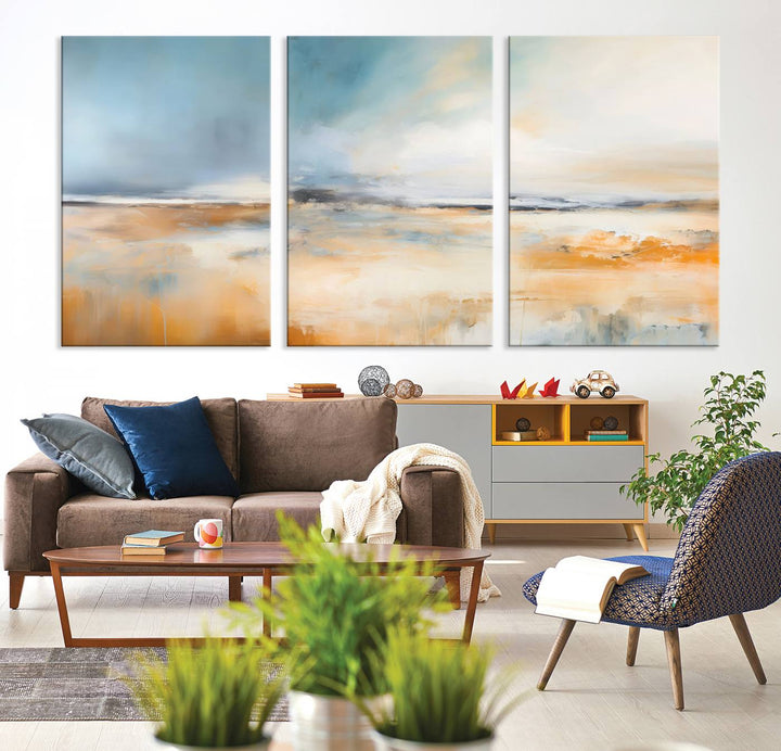 The Abstract Landscape Wall Art Canvas Print, featuring warm tones of orange and blue, is displayed on a dark wall.