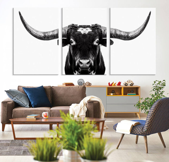 The living room is adorned with the Texas Cow Longhorn Wall Art Canvas Print in Black and White—framed and ready to hang.