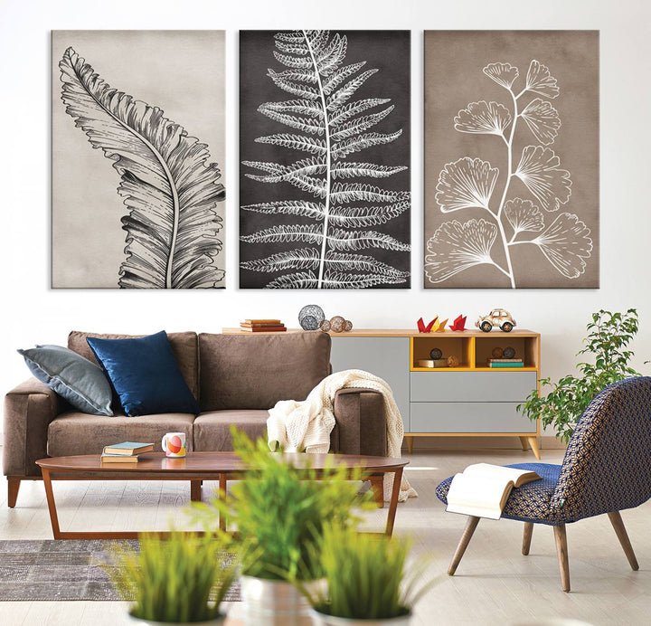 The Botanical Leaf Art Collection - 3-Panel Wall Art Canvas Print is framed above a modern console table.