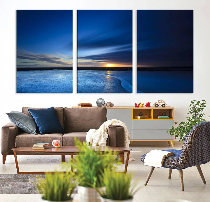 The living room features a triptych of the Wall Art Canvas Print Navy Sunset Lake Landscape Artwork, adding to its tranquil vibe.