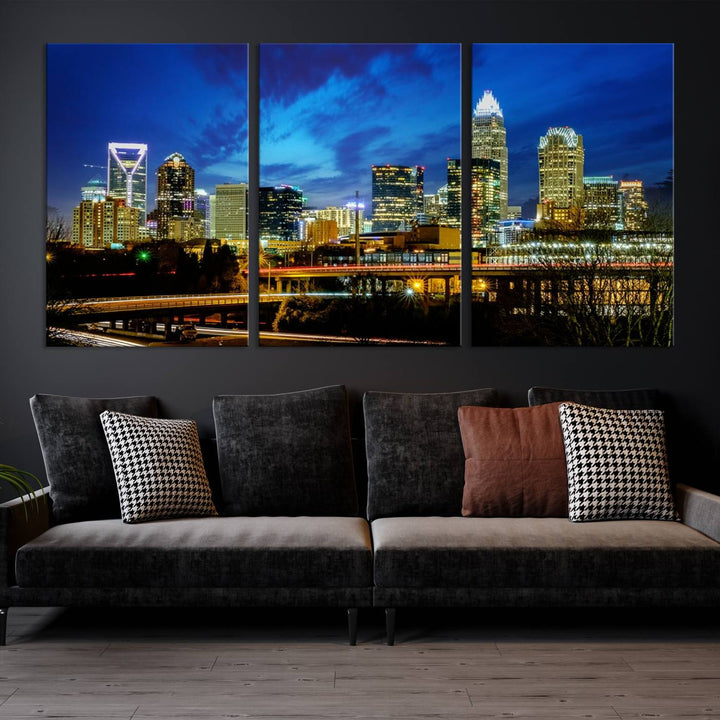 A modern living room highlighted by the "Charlotte City Lights Cloudy Blue Night Skyline Cityscape View" wall art canvas print, crafted on museum-quality canvas with UV-protective coating.