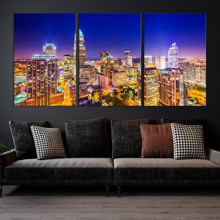 A modern living room features the Charlotte City Lights Night Blue Skyline Cityscape View wall art canvas print.