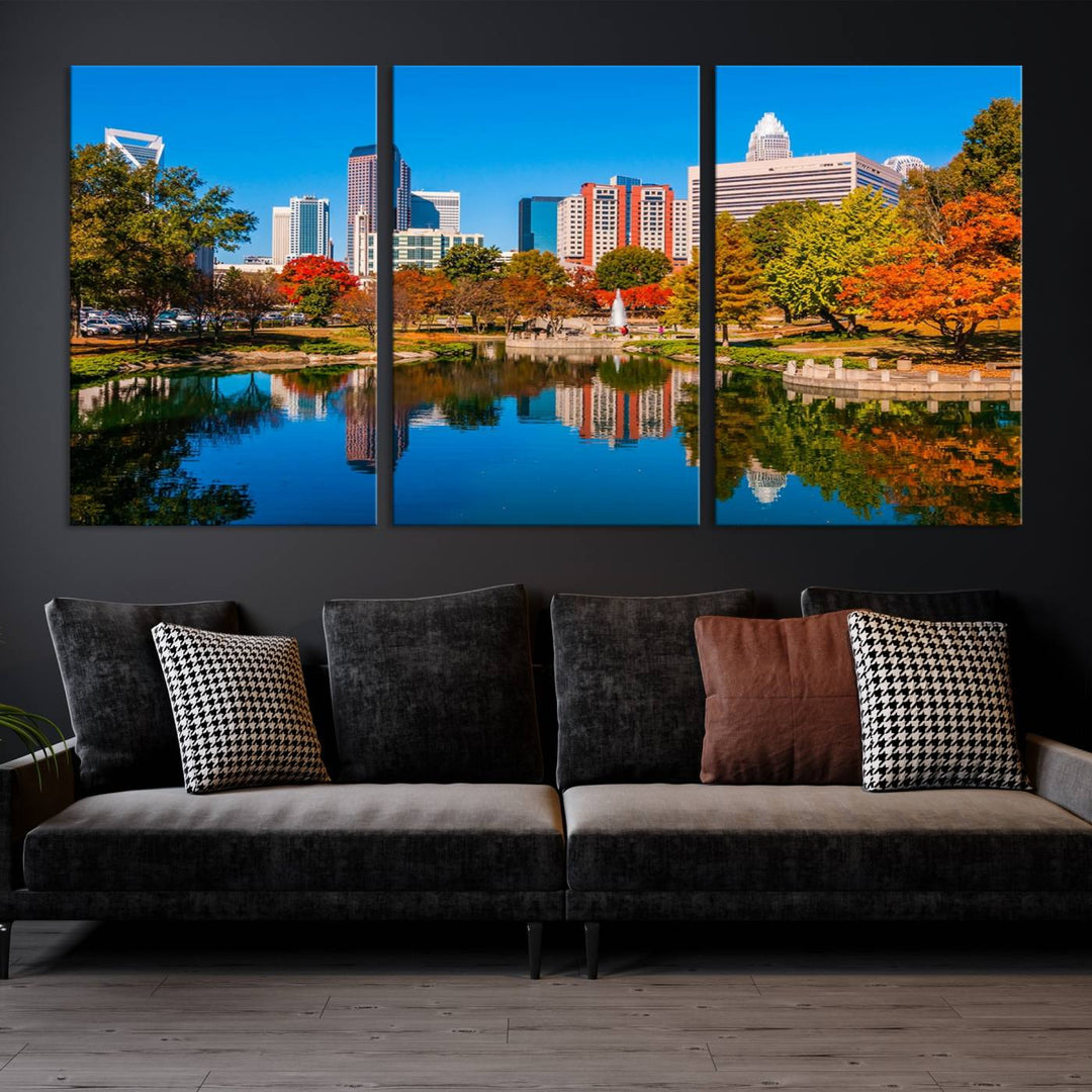 The "Charlotte City Autumn Morning Blue Skyline Cityscape View Wall Art Canvas Print" showcases a cityscape with vibrant autumn trees reflected in a lake. Its gallery-wrapped edges add depth to the scene, while the UV-protective coating ensures lasting brilliance.