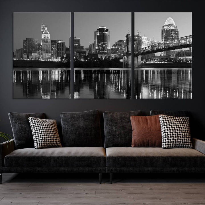 The wall showcases a ready-to-hang triptych of the Cincinnati City Lights Skyline in black and white, printed on museum-quality canvas.