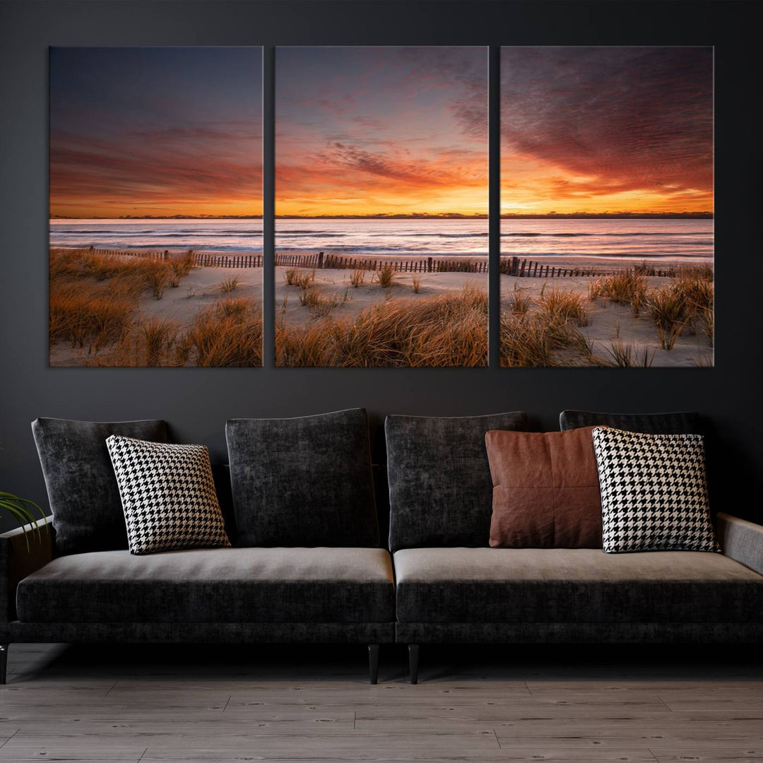 Sunset on The Beach Wall Art Canvas Print features a triptych of a beach at sunset with vivid orange skies, presented on museum-quality canvas. Each section is gallery wrapped, offering lasting beauty with its UV-protective coating.