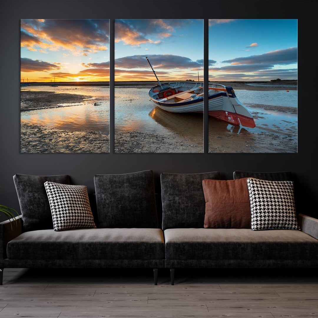 The "Small Boat At The Beach Sunset Wall Art Canvas Print," a three-panel masterpiece crafted on museum-quality canvas, hangs elegantly.