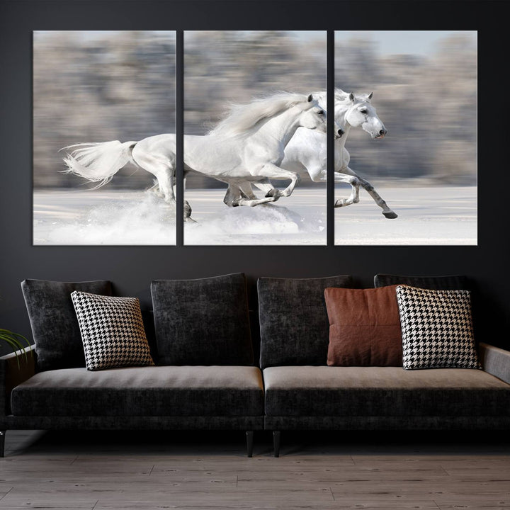 The "All The White Horses Wall Art Canvas Print" depicts a triptych of galloping white horses across a snowy landscape. These museum-quality canvases come with a UV-protective coating to maintain their stunning appearance over time.