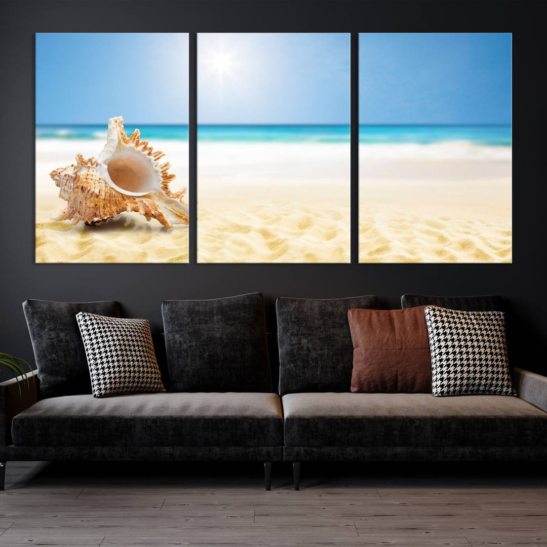 The Sea Shell on The Beach Sun Sand Wall Art Canvas Print is a triptych that beautifully captures a beach scene with a large seashell on the sand.