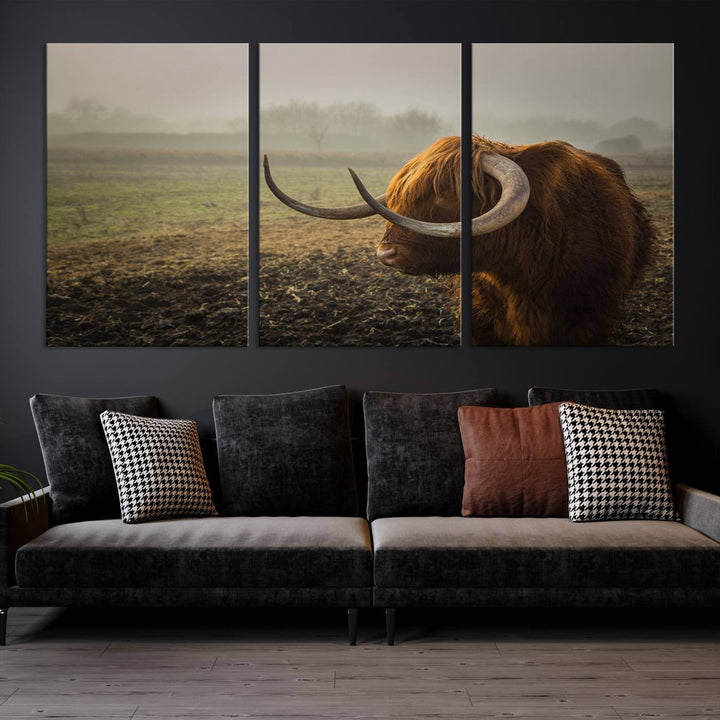 The "Big Cow Horn Wall Art Canvas Print" is a hand-assembled framed canvas depicting a Highland cow in a misty field. It is crafted with a UV-protective coating to ensure lasting vibrancy.