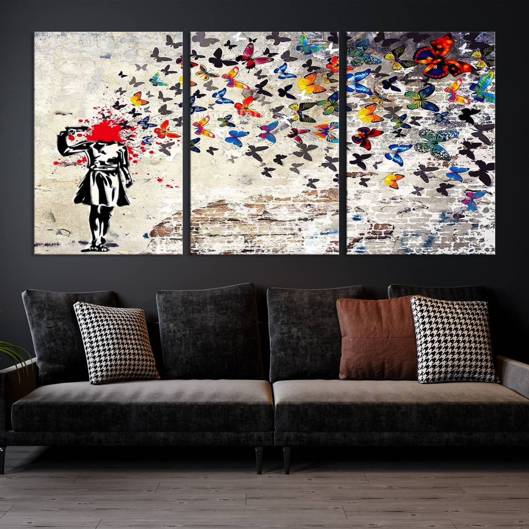 The Banksy Art Butterfly Girl Explosion Canvas showcases a dynamic figure with butterflies bursting from their head, set against a textured wall background. This vibrant urban graffiti piece is perfect for modern interiors and comes ready to hang.