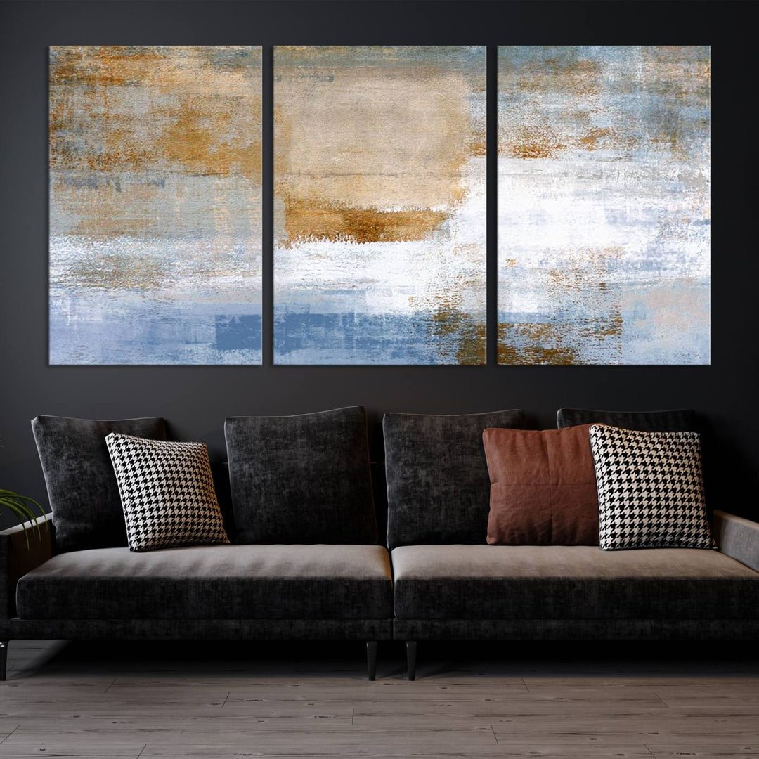 The Blue Multi Panel Abstract Wall Art Canvas Print, featuring an elegant blend of blue, beige, and brown tones, hangs gracefully on the wall, adding a contemporary touch to the space.