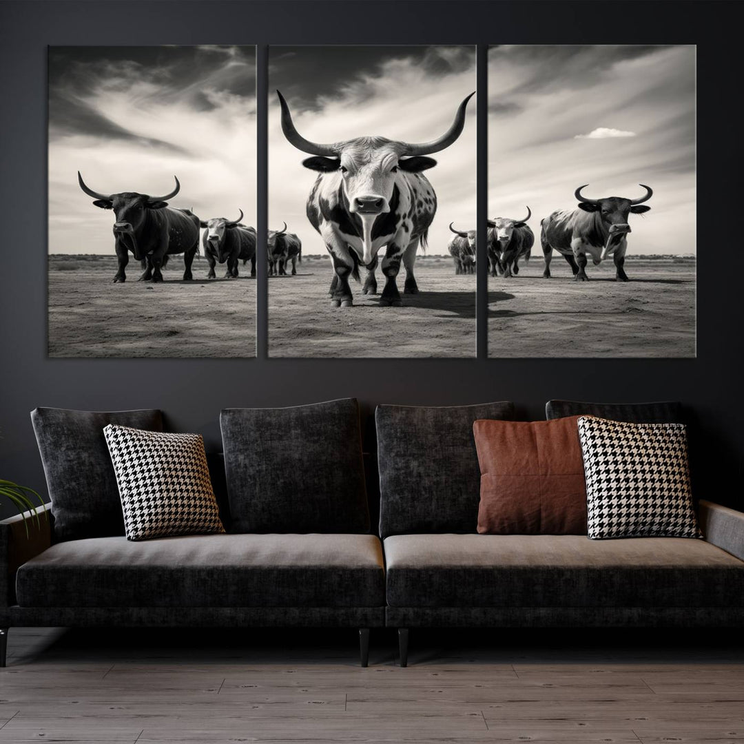 The Black and White Longhorn Cattle Wall Art, featuring a three-panel display of cowboy Western longhorns walking toward the viewer, enhances your space with its striking presence, adding a touch of Western decor.