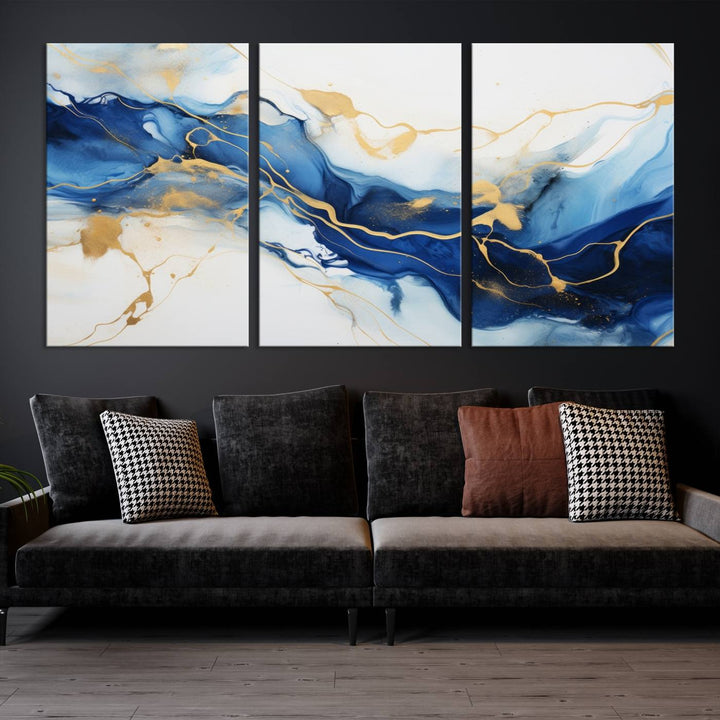 The Blue Abstract Wall Art is displayed as a triptych on museum-quality canvas, showcasing a blue and gold abstract design. The artwork includes a UV-protective coating to maintain its vibrancy and comes with the benefit of free shipping.