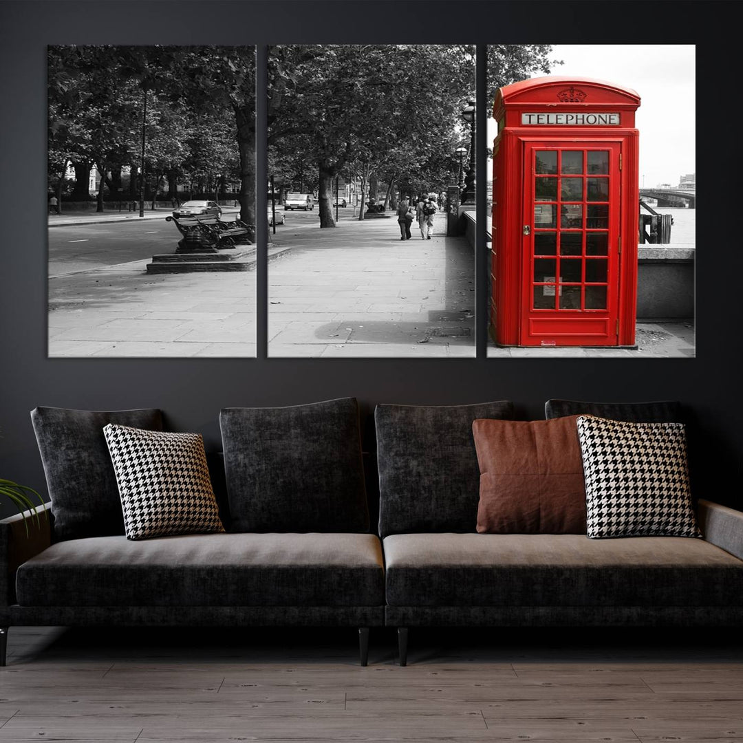 The London Phone Club Wall Art is a stunning piece that showcases a red telephone box set in a black and white street scene on museum-quality canvas. It is gallery wrapped with a UV-protective coating to preserve its vibrant charm.