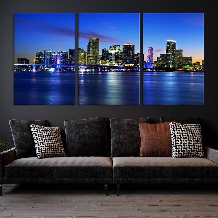 The modern living room showcases a striking Miami Blue Night Wall Art canvas print on the wall. The artwork is gallery wrapped on museum-quality canvas, ensuring durability and elegance.