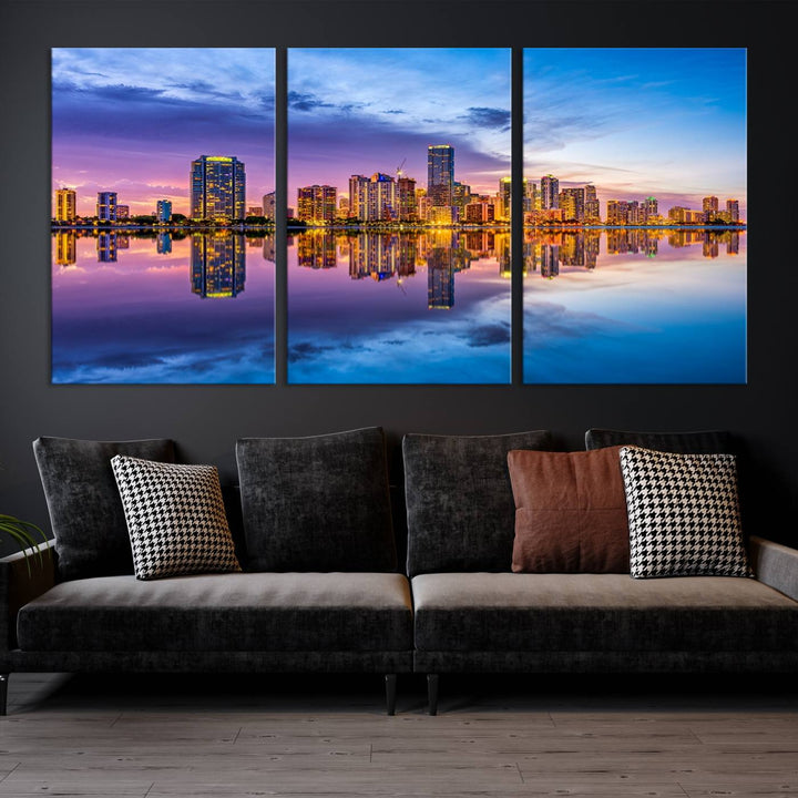 The Miami City Wall Art Canvas Print, featuring a three-panel depiction of a city skyline at sunset reflected in water, beautifully enhances the wall. Made with museum-quality canvas and a UV-protective coating, it comes ready to hang.