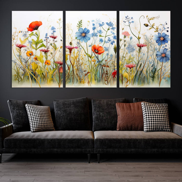 The Colorful Wildflower Canvas Wall Art – Vibrant Floral Botanical Print, consisting of a large 3 panel set, adds bright nature decor to the living room against a black wall.