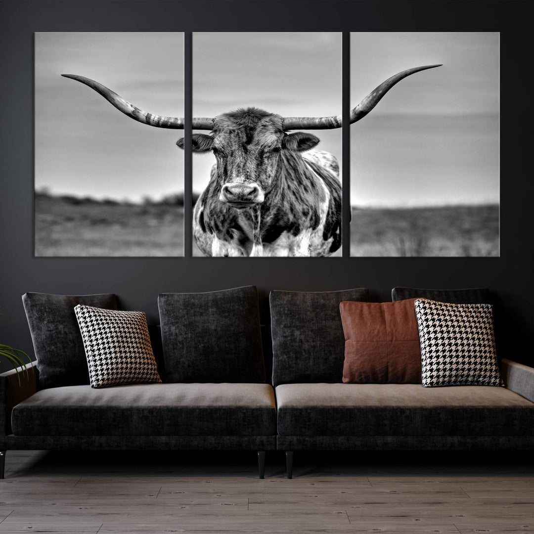 The Texas Longhorn Cow Wall Art, featuring a black and white image of a longhorn bull on canvas, brings charm to the room with its sophisticated appeal.