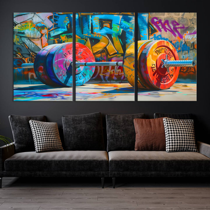 The Fitness Gym Barbell Graffiti Wall Art Canvas Print, a vibrant triptych featuring a barbell against a graffiti backdrop, elegantly hangs in the room. Crafted on premium canvas with a gallery-quality finish, this stunning piece of wall art effortlessly combines urban flair with sophisticated decor.