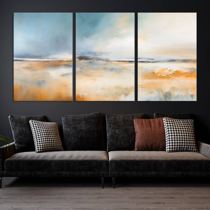 The Abstract Landscape Wall Art Canvas Print, featuring warm tones of orange and blue, is displayed on a dark wall.