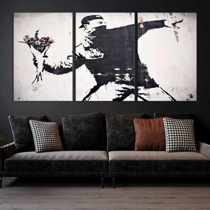 The living room features a split-panel art piece named "Banksy Flower Throw Graffiti Street Wall Art Canvas Print," gallery wrapped on museum-quality polycotton canvas and accentuated by modern decor elements.