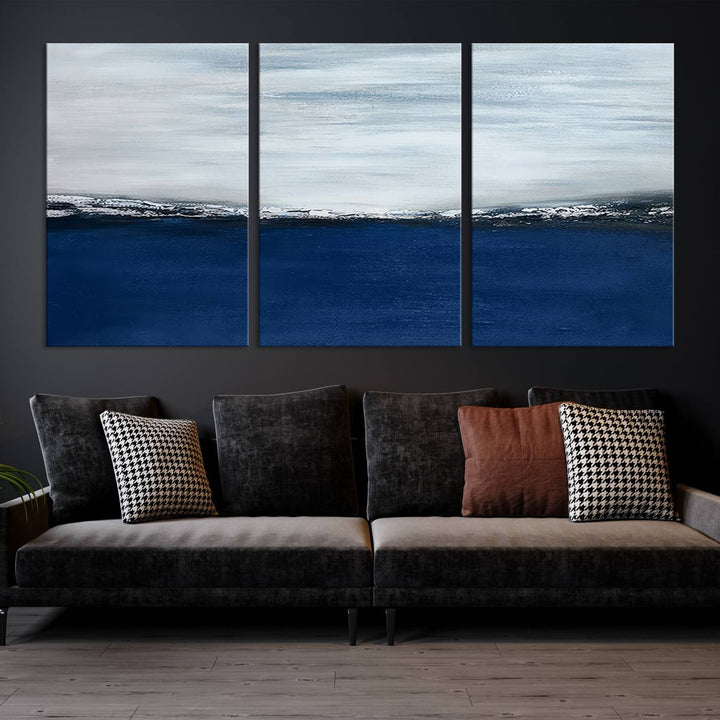 The modern living room is enhanced by the Navy Blue Abstract Wall Art Canvas Print on the wall, crafted as handmade wall art with a gallery-quality finish.