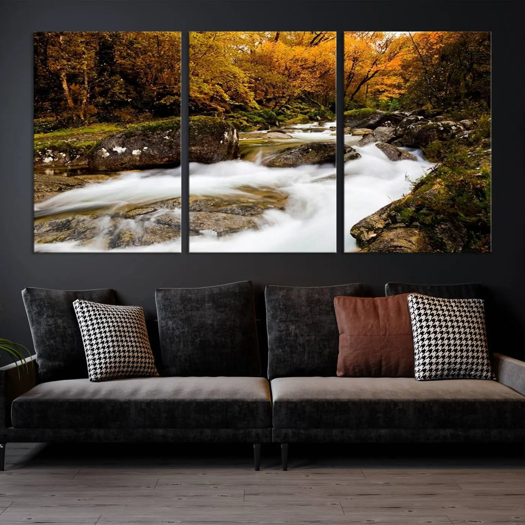 The living room is adorned with the "Wall Art Waterfall Canvas Print River in Forest in Autumn," a triptych on museum-quality canvas showcasing a flowing river surrounded by autumn trees. This ready-to-hang artwork features a UV-protective coating to ensure enduring vibrancy.