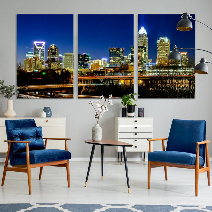 The Charlotte City Lights Night Blue Skyline Cityscape View Wall Art Canvas Print, showcasing an illuminated city skyline at night, is printed on museum-quality canvas with a UV-protective coating. Enhance your space with this stunning piece and enjoy free shipping with your purchase.