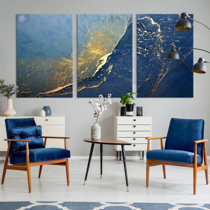 The Navy Blue Yellow Twinkle Wall Art Canvas Print, featuring an abstract design in gold and blue, enhances a modern living room as it adorns a white wall with its gallery-wrapped, museum-quality canvases for an exquisite touch.