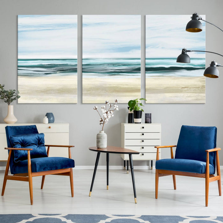 The room features the Ocean Abstract Wall Art Canvas Print, a triptych beach painting on museum-quality canvas with a gallery-wrapped finish and UV-protective coating.