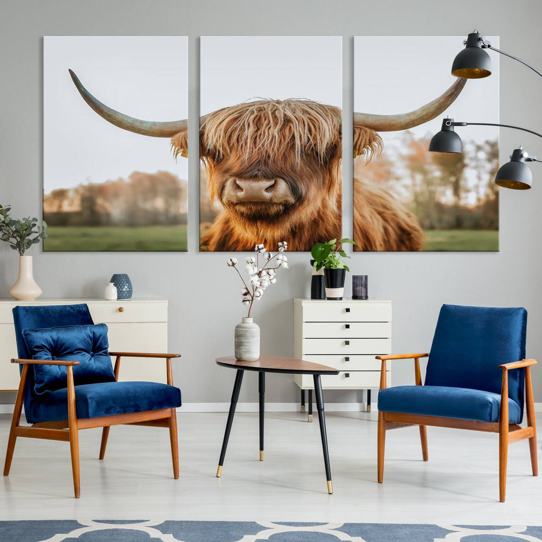 A Highland Cow Animal Scottish Cattle Art Print Farmhouse Wall Art Canvas Print hangs in the living room, adding a touch of rustic farmhouse decor.