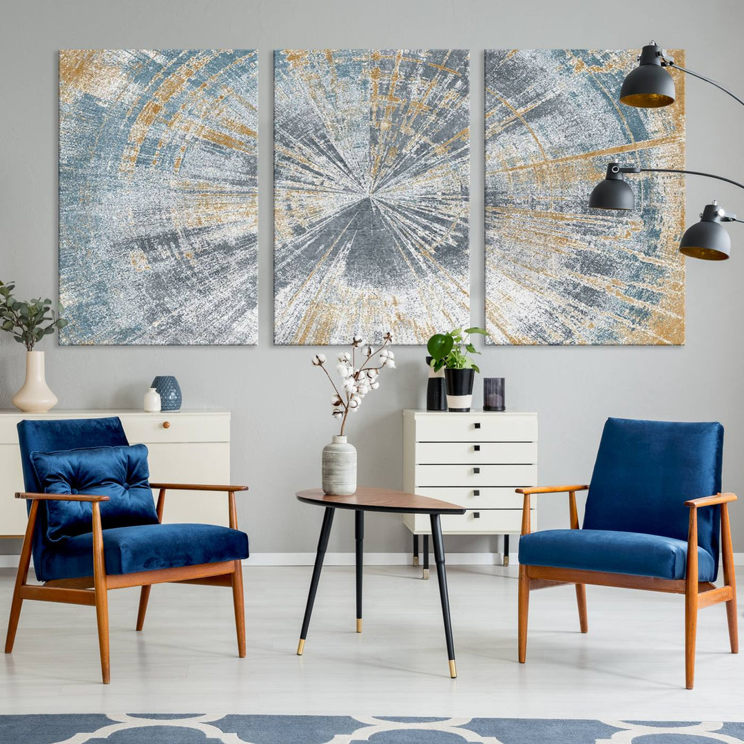 The Radiant Abstract Wood Rings Canvas Art, a modern triptych wall decor, enhances the contemporary style of the living room with its blue, white, and gold hues.