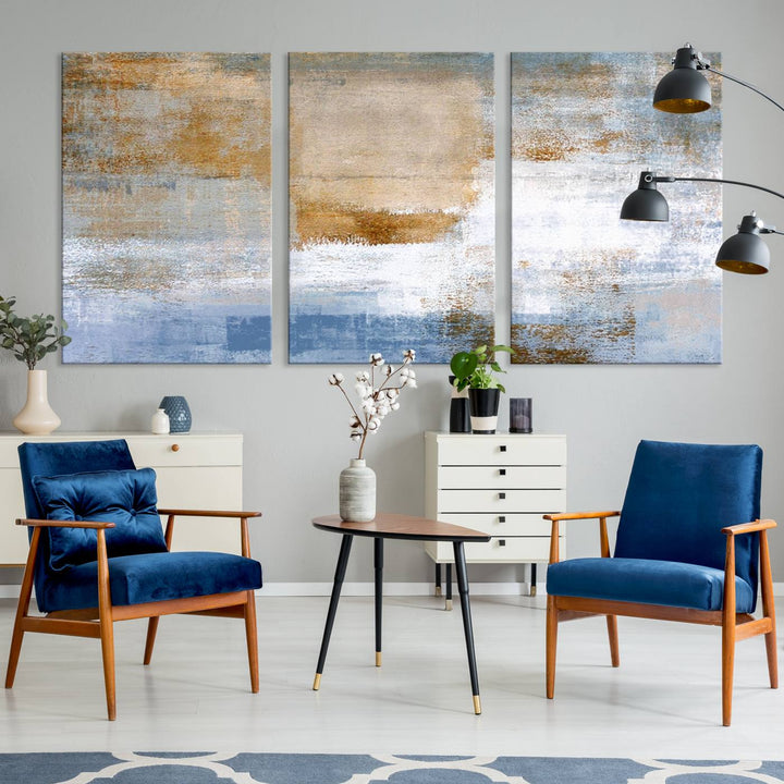 The Blue Multi Panel Abstract Wall Art Canvas Print, featuring an elegant blend of blue, beige, and brown tones, hangs gracefully on the wall, adding a contemporary touch to the space.