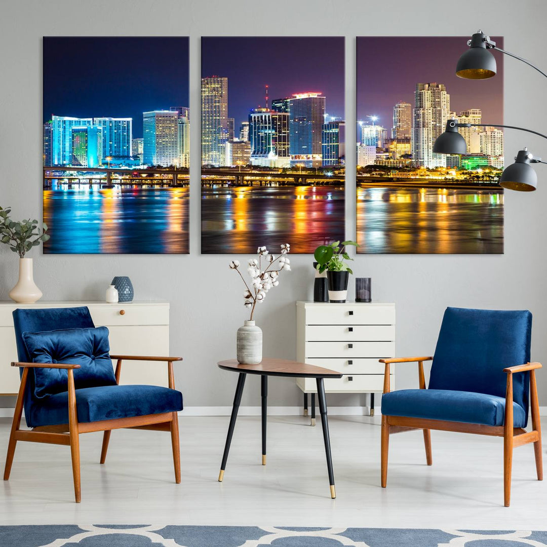 The Wall Art MIAMI Canvas Print features a stunning triptych of a city skyline at night, with vibrant lights reflecting on the water. This gallery-wrapped piece on museum-quality canvas delivers an exquisite finish.