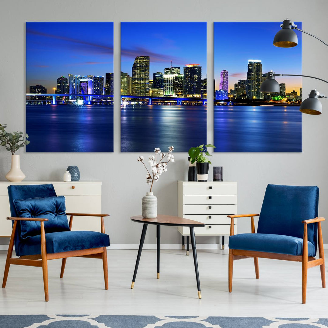 The modern living room showcases a striking Miami Blue Night Wall Art canvas print on the wall. The artwork is gallery wrapped on museum-quality canvas, ensuring durability and elegance.