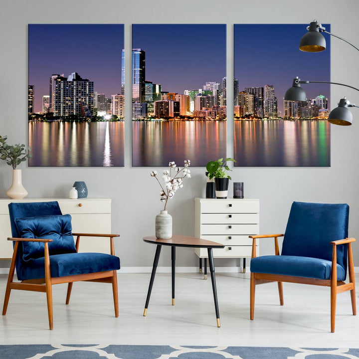 The Miami Skyline Canvas Wall Art Print showcases a vibrant night cityscape and beautifully captures the dazzling colorful lights reflecting on the water. This ready-to-hang triptych adorns the wall, creating a stunning visual centerpiece.