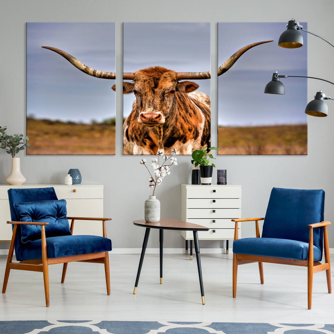 The Texas Longhorn Wall Art Print, a triptych canvas artwork depicting a longhorn bull in a field, features a gallery-quality finish.